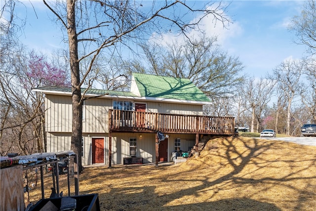 rear view of house featuring a wooden deck