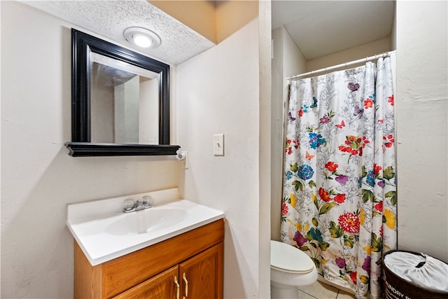 bathroom featuring toilet, vanity, a shower with shower curtain, and a textured ceiling