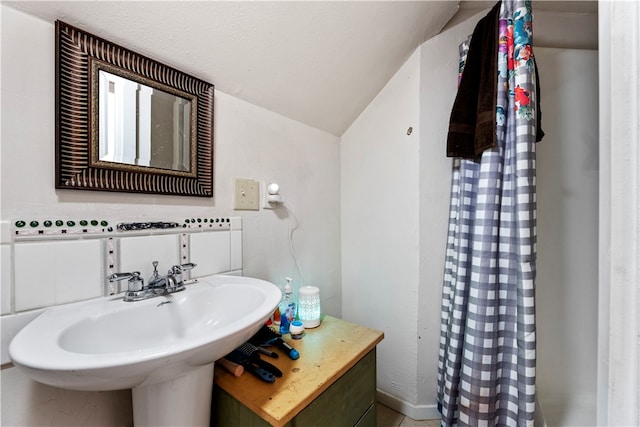 bathroom with sink and vaulted ceiling