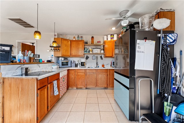 kitchen with sink, ceiling fan, light tile patterned floors, decorative light fixtures, and white appliances