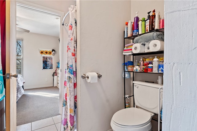 bathroom with tile patterned flooring, a textured ceiling, and toilet