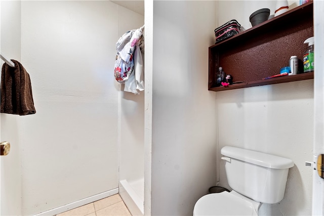 bathroom featuring toilet, walk in shower, and tile patterned floors