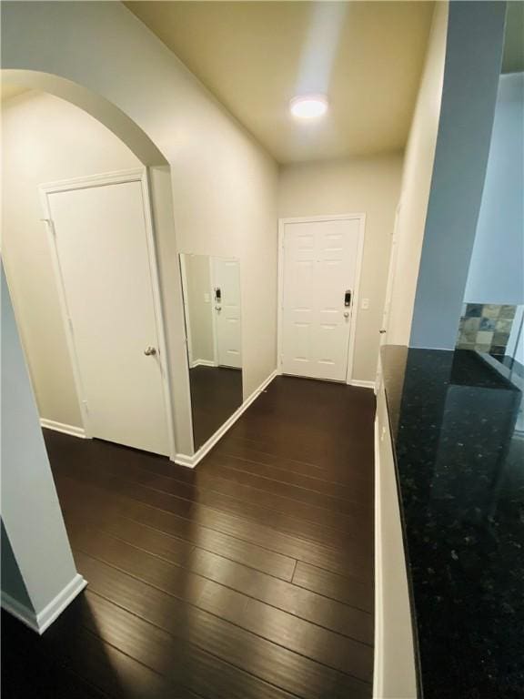 hallway with dark hardwood / wood-style floors