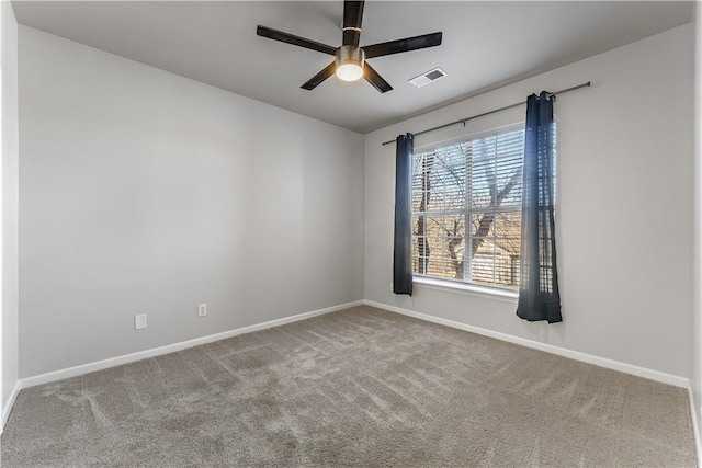 spare room with ceiling fan and carpet