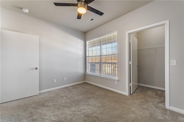 unfurnished bedroom featuring light colored carpet, ceiling fan, and a closet