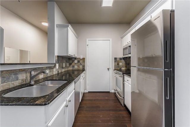 kitchen featuring sink, white cabinets, tasteful backsplash, and appliances with stainless steel finishes