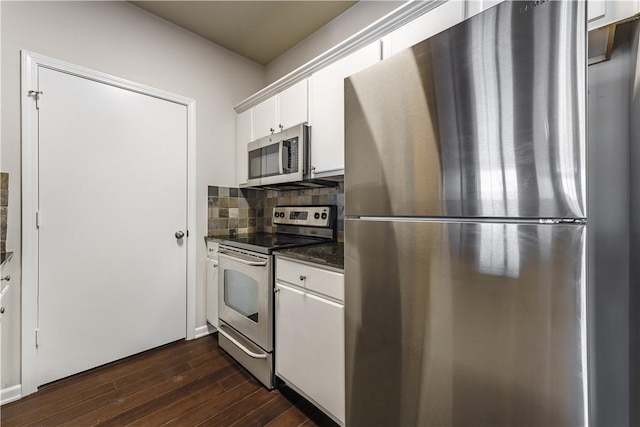 kitchen featuring dark hardwood / wood-style flooring, white cabinets, decorative backsplash, and appliances with stainless steel finishes