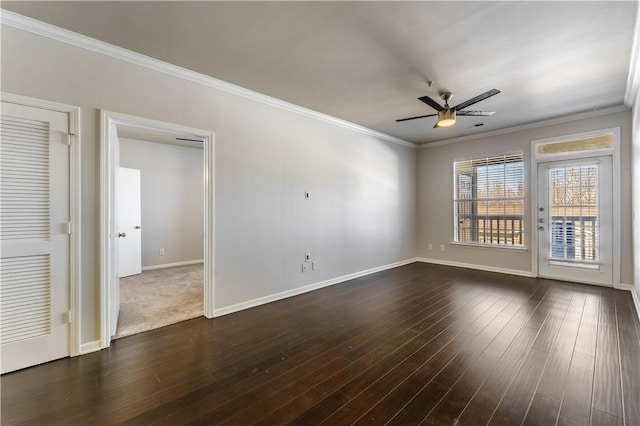 spare room with ornamental molding, dark wood-type flooring, and ceiling fan