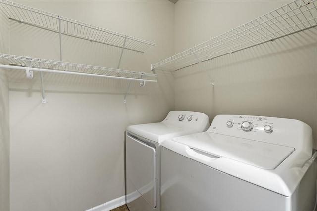 clothes washing area with washing machine and clothes dryer