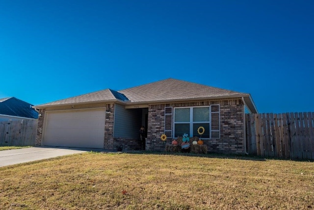 view of front of property featuring a garage and a front lawn