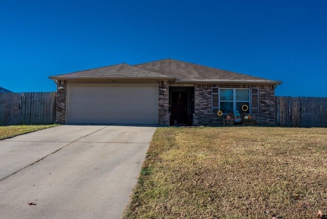 single story home with a front yard and a garage