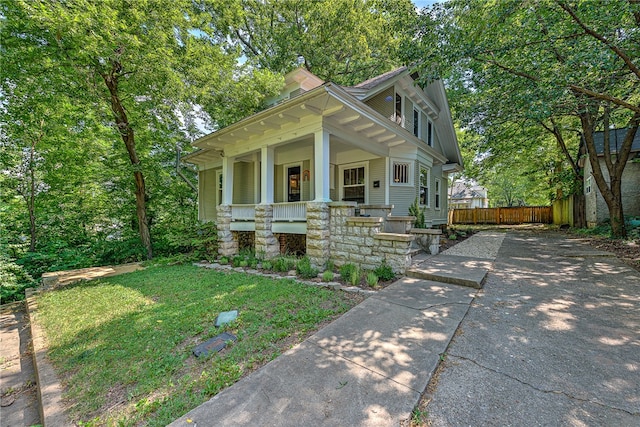 view of front of property with a porch and a front yard