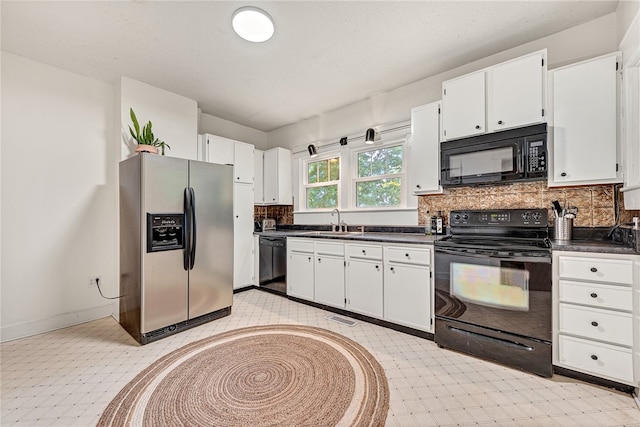 kitchen with decorative backsplash, black appliances, and white cabinetry