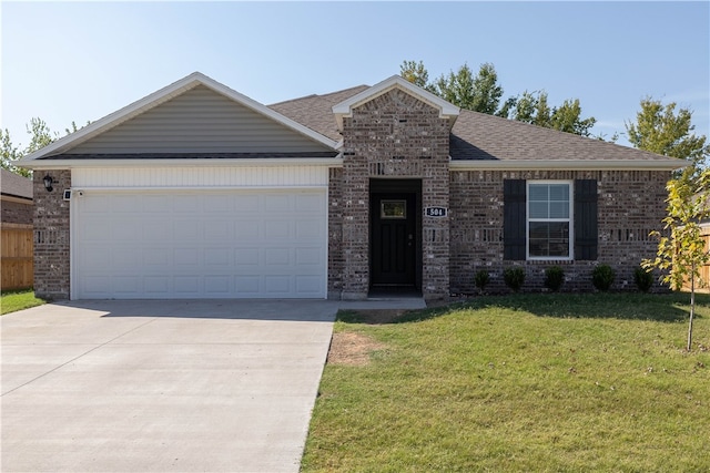 view of front facade featuring a front yard and a garage