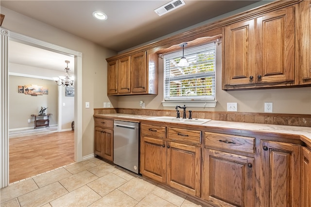 kitchen featuring hanging light fixtures, dishwasher, an inviting chandelier, light hardwood / wood-style flooring, and sink