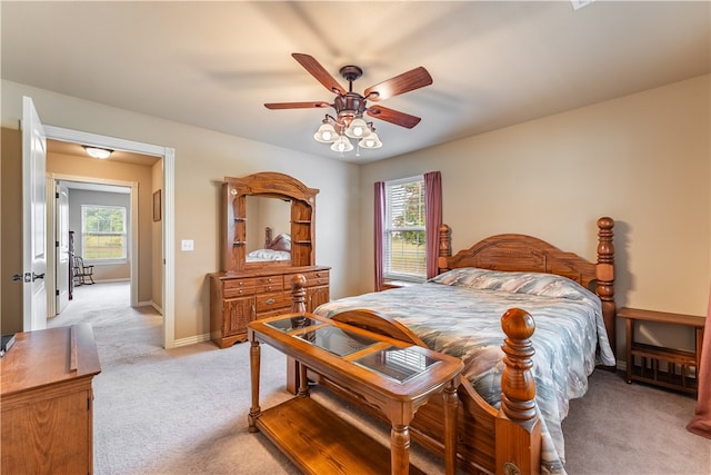 bedroom with light carpet and ceiling fan