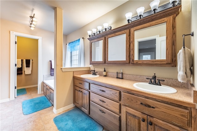 bathroom with a bathing tub, vanity, and tile patterned floors