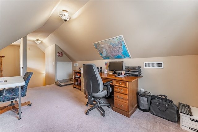 carpeted office with lofted ceiling