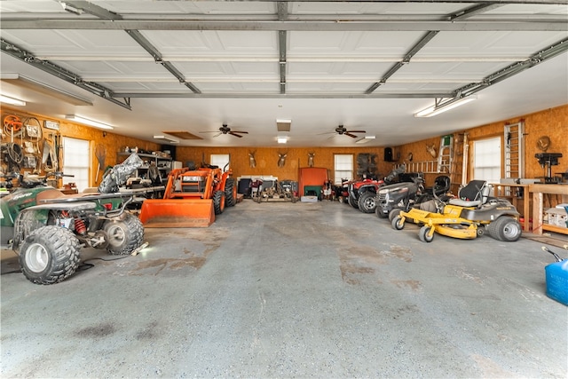 garage featuring wooden walls and ceiling fan