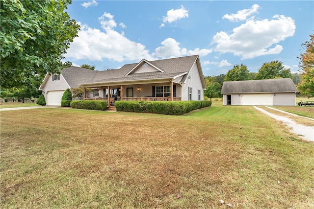 view of front of home featuring a front lawn, a garage, and covered porch