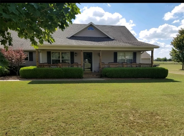 view of front of house with a porch and a front yard