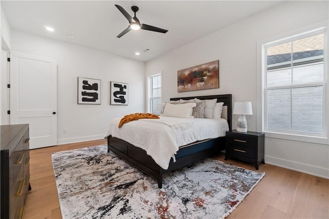 bedroom featuring a ceiling fan, baseboards, recessed lighting, and light wood-style floors