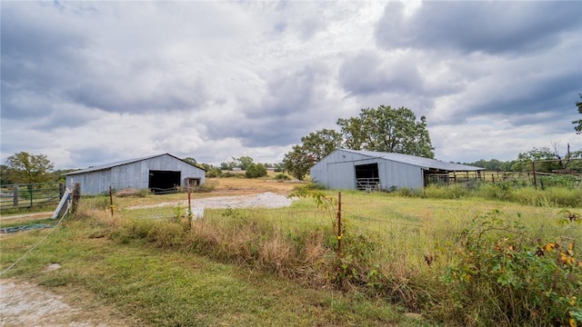 view of yard with a rural view and an outdoor structure