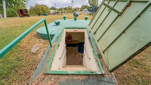 view of storm shelter featuring a lawn