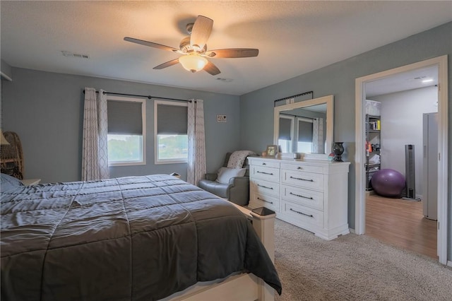 bedroom with ceiling fan and light carpet