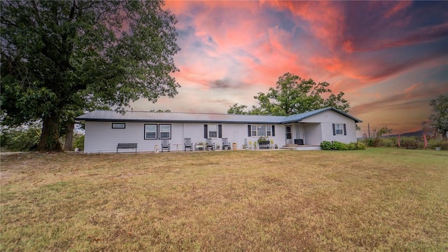 view of front of property with a lawn