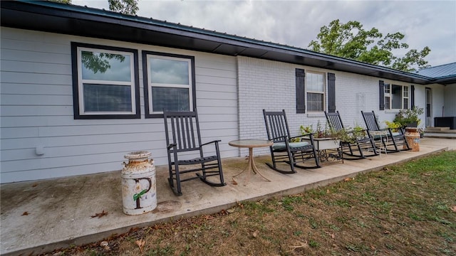 back of property featuring covered porch