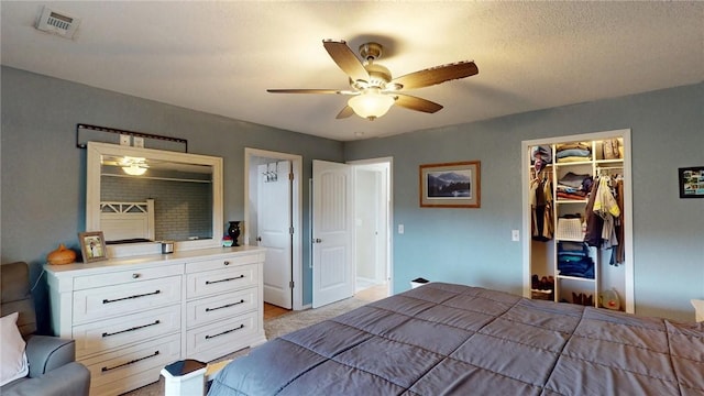 bedroom with ceiling fan, a closet, and a spacious closet