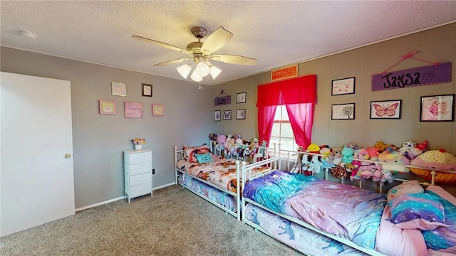 bedroom with ceiling fan, carpet flooring, and a textured ceiling