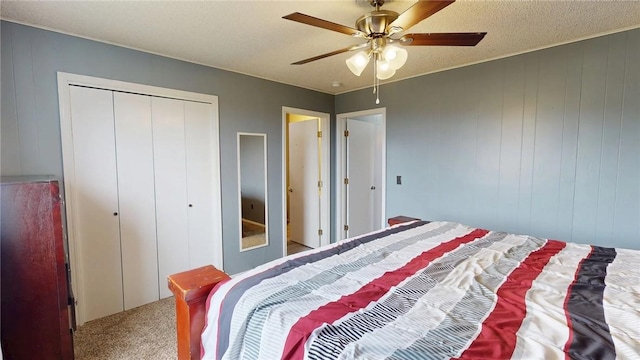 bedroom featuring carpet, a closet, ceiling fan, and a textured ceiling