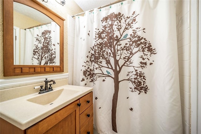 bathroom with a textured ceiling and vanity