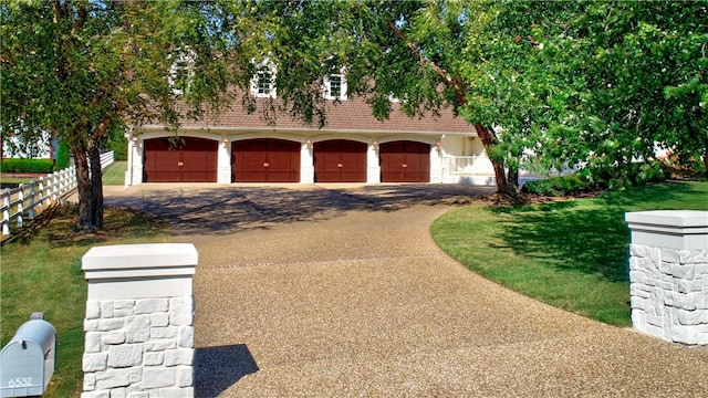 view of front of property with a front yard and a garage