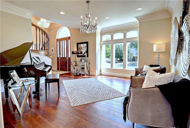 living room featuring ornamental molding, a chandelier, and dark hardwood / wood-style flooring