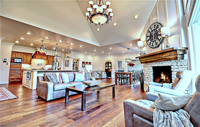 living room featuring a notable chandelier, high vaulted ceiling, dark hardwood / wood-style floors, and a fireplace