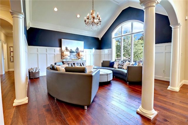 living room featuring dark wood-type flooring and ornate columns