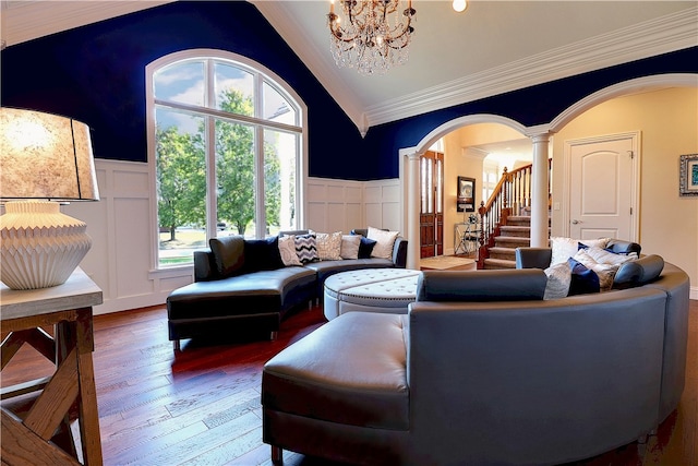 living room featuring ornate columns, hardwood / wood-style flooring, plenty of natural light, and vaulted ceiling