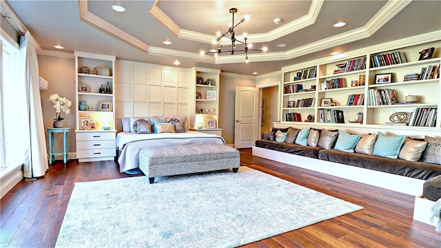 bedroom featuring a raised ceiling, ornamental molding, dark hardwood / wood-style flooring, and a chandelier