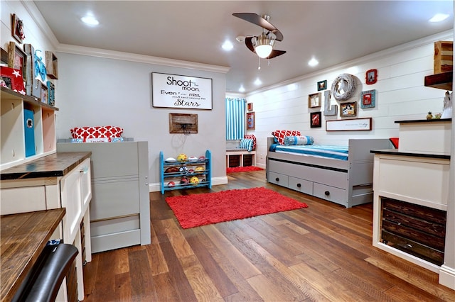 bedroom featuring ceiling fan, ornamental molding, and dark hardwood / wood-style flooring