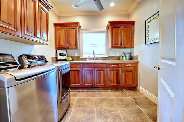 laundry room with ceiling fan, sink, cabinets, crown molding, and washer and dryer