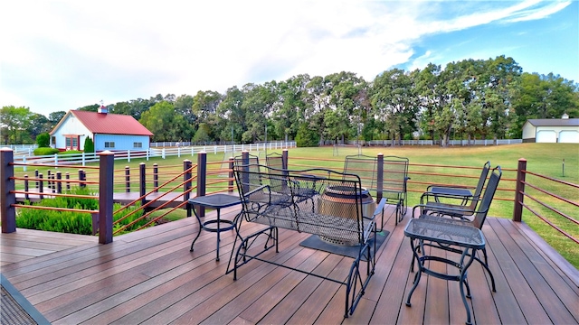 deck featuring a lawn and an outbuilding