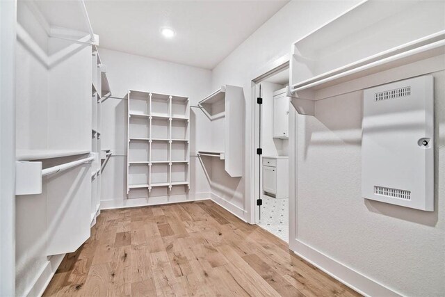 spacious closet featuring light wood-type flooring