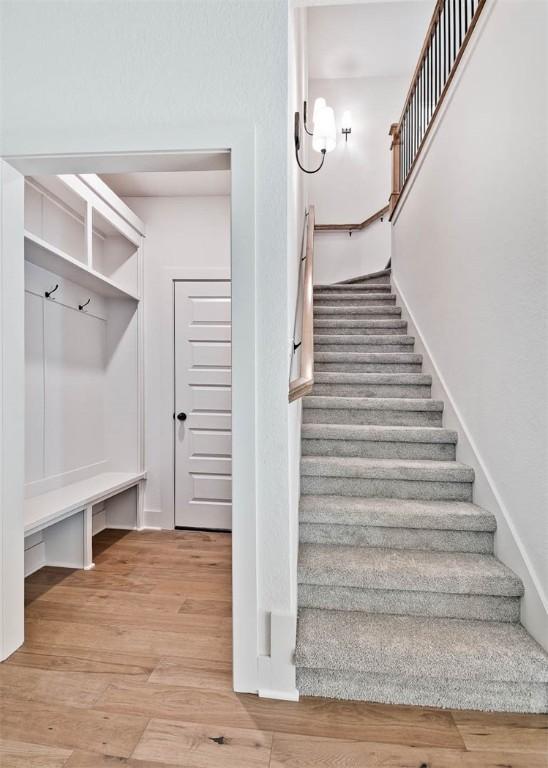 stairway with hardwood / wood-style flooring