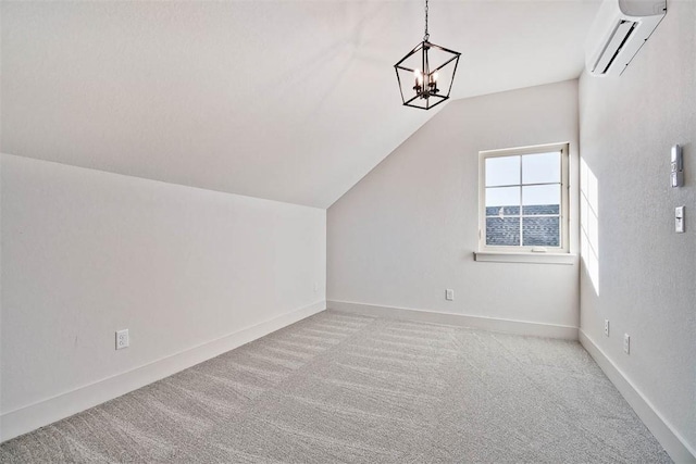 additional living space featuring vaulted ceiling, light carpet, a wall mounted AC, and an inviting chandelier