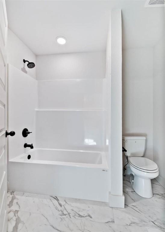 bathroom with shower / tub combination and toilet