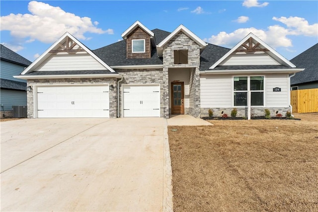 craftsman-style home with a garage, a front lawn, and central AC