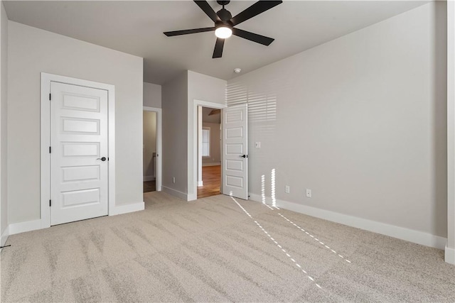 unfurnished bedroom featuring ceiling fan and light carpet